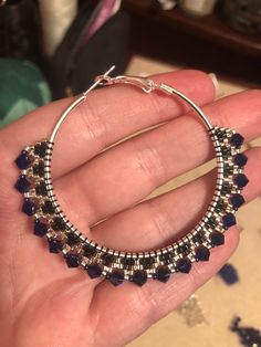 Glittering and elegant, these large hoops are sure to turn heads! Featuring lots of swar0vski crystal, glass beads, and 50mm sterling silver plated steel hoops with locking backs. Crystals are a deep cobalt blue that brightens with the surrounding light. Elegant Beaded Sterling Silver Hoop Earrings, Silver Beaded Hoop Earrings In Sterling Silver, Silver Sterling Beaded Hoop Earrings, Silver Beaded Sterling Silver Hoop Earrings, Silver Beaded Hoop Jewelry, Silver Hoop Beaded Jewelry, Silver Metal Beaded Hoop Earrings, Handmade Silver Crystal Hoop Earrings, Elegant Party Hoop Earrings With Faceted Beads