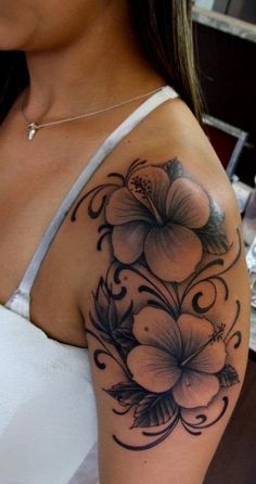 a woman with a flower tattoo on her shoulder