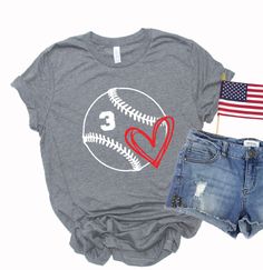 a t - shirt and shorts with the number 3 on it, next to an american flag