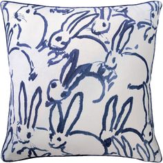 a blue and white pillow with rabbits on it