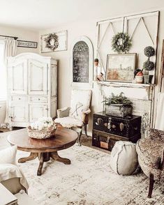 a living room filled with lots of furniture and decor on top of a white rug