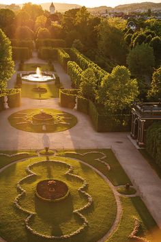 an aerial view of a formal garden at sunset