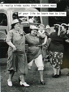 an old black and white photo of women dancing in front of a van with flowers on its head