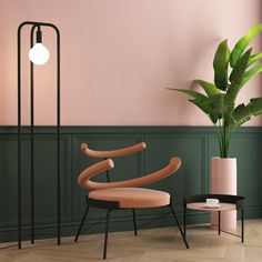 a chair and table in a room with a plant on the floor next to it