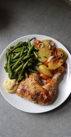 a white plate topped with meat and veggies