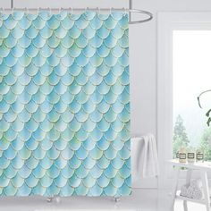 a bathroom with a shower curtain that has fish scales on it and is next to a bath tub