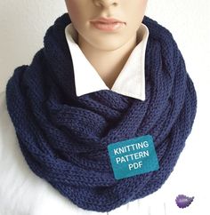 a mannequin wearing a knitted scarf with a knitting pattern on the label