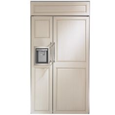 a white refrigerator freezer sitting inside of a wooden cabinet next to a metal door