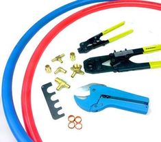 various tools are laid out on top of a white surface with red, blue and yellow hoses