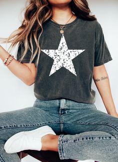 Distressed Star Comfort Colors Shirt, Big Star t-shirt, 4th of July shirt, Patriotic shirt, Memorial Day, Women, Men's Star Tee, America 🎈WELCOME TO UNIQUE TRENDS DESIGN  If you are looking for soft, comfy, first-rate t-shirts, you're in the right place! Here at Unique Trends Design, we love what we do and strive to make your shopping experience just right for you. If you have any questions, concerns, or comments about our products, feel free to shoot us a message anytime. Even on weekends and holidays, we'll try our best to respond as quickly as possible! 🎈Product Details  Unisex T-Shirt: - Comfort Colors Brand - 100% cotton - Light/medium weight and extremely soft, this shirt is sure to be your next favorite t-shirt. 🎈Sizing and Coloring  Please make sure you select the right color an Casual Crew Neck T-shirt With Star Patch, Cotton Crew Neck T-shirt With Star Patch, Casual Tops With Star Logo And Relaxed Fit, Relaxed Fit Short Sleeve Tops With Star Logo, Graphic Tee Shirt With Star Print And Crew Neck, Cotton Crew Neck Top With Star Patch, Casual Short Sleeve Shirt With Star Print, Casual Star Print Short Sleeve Shirt, Cotton Crew Neck Shirt With Star Print