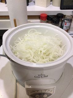 a bowl filled with shredded white onions on top of a counter