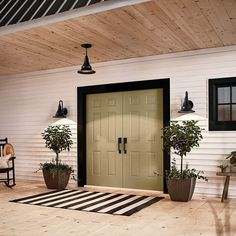 a front porch with potted plants and two doors