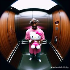 a man in a hello kitty outfit holding a stuffed animal