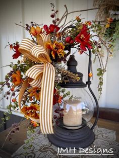 a lantern with flowers and a bow on it