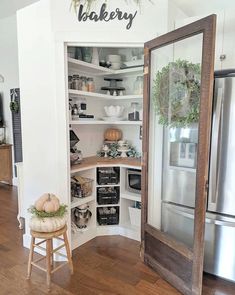 an open pantry with shelves filled with dishes and other kitchen items, including pumpkins