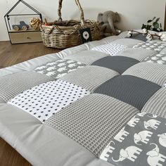 an elephant themed quilt on a bed in a child's room