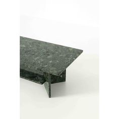 a green marble coffee table sitting on top of a white floor