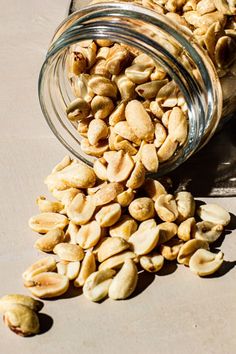 a jar filled with nuts sitting on top of a table