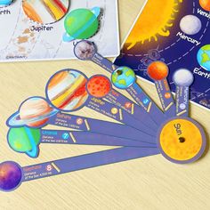 the solar system and its planets are shown on a table next to some cards with pictures