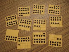 several pieces of yellow paper with black dots on them