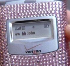 a person holding a pink cell phone in their left hand and the screen is covered with silver sequins