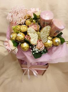 a pink box filled with chocolates and flowers