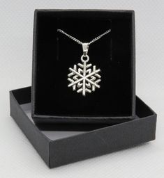 We offer a gift wrapping service for a small charge so you can send your items directly to your friend or loved one - gift wrapped and ready to open! This beautiful pendant necklace is sure to bring joy and festive cheer to any outfit. Perfect for holiday parties or as a thoughtful gift. ~Tibetan silver - Snowflake ~Double sided cut out detailed design  ~Charm size 15 mm x 15 mm ~Sterling Silver medium curb chain necklace with spring ring clasp ~Choose either 18 or 24 inch chain ~Sterling Silver Bridal Bouquet Charms, Gold Glitter Stars, Beautiful Pendant Necklace, Bouquet Charms, Snow Ice, Curb Chain Necklace, Wine Glass Charms, Blue Gift, Star Gift