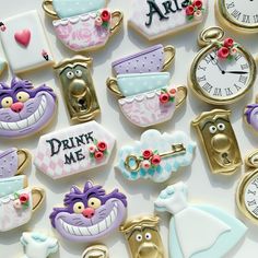 many decorated cookies with different designs and words on them, including the word drink me