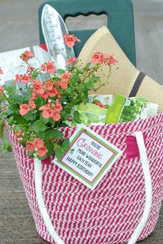 a red and white shopping bag with flowers in it