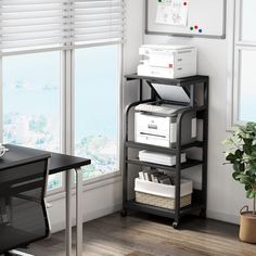 a black and white shelf with some papers on it next to a plant in front of a window