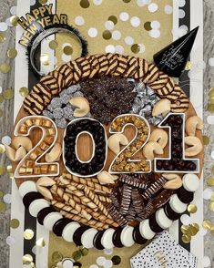 a happy new year card made out of cookies and candies, with the number 2012 spelled in large letters