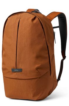 a brown backpack sitting on top of a white surface