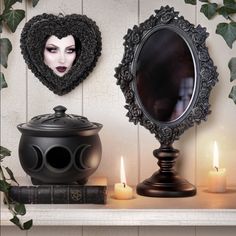 there is a mirror and some candles on the mantle next to each other with an image of a woman's face