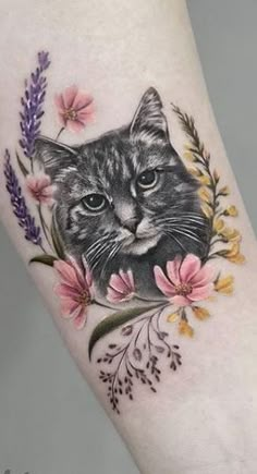 a cat with flowers on it's arm