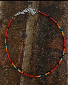 Czech beaded choker with color variations of red, turquoise, black, orange, and yellow. Adjustable choker style necklace. Western Style Beaded Necklace, Western Chokers Beaded, Western Beaded Necklace, Sead Bead Necklace, Rocker Necklace, Black Beads Necklace, Rodeo Jewelry, Simple Beaded Necklaces, Black Beaded Necklace