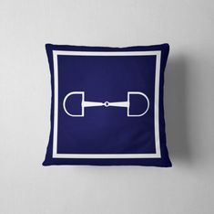 a blue pillow with a white border and an image of a pair of scissors on it