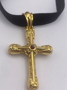 vintage Celtic Gold Stainless Steel Cross pendant necklace Has a red crystal set on  both sides.  Very solid Gothic cross Vintage design  Silver stainless steel  Over an inch Hangs on a velvet ribbon,  Can be worn on a chain.  All jewelry is shipped in a nice gift box.   Check out our over a THOUSAND great reviewsh Costume Jewelry Cross Necklace As Gift, Formal Cross-shaped Metal Jewelry, Costume Jewelry Cross-shaped Gift, Ornate Gold Cross Pendant Necklace, Vintage Cross Necklace Collectible, Vintage Red Cross Jewelry, Medieval Cross Pendant Necklace Gift, Gothic Gold Cross Pendant Jewelry, Red Gothic Cross Necklace