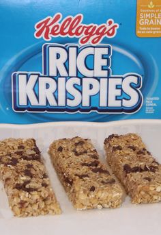 three granola bars on a white plate next to a box of rice krispies