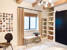 a living room filled with furniture next to a window covered in pictures and bookshelves