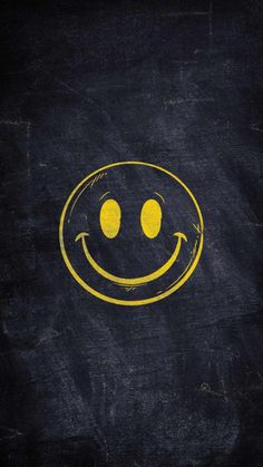 a yellow smiley face drawn on a black background