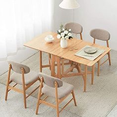 a wooden table with four chairs around it