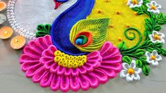 a colorful peacock with flowers and candles around it