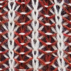 an image of a red and white knitted material with lines in the middle that are diagonally linked