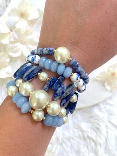 This bracelet stack features a variety of beads and gemstones in complementary hues of blue, white, ivory, and gold. These bracelets are made with stretch elastic. Please take care not to overextend your bracelets. To wear, gently roll them off and on your wrists. Each bracelet comes in a standard size of 7 inches. If you need a slightly smaller or larger size, please message me prior to purchasing and I will be happy to accommodate you. All bracelets are made to order. Each style is sold separa Floral Bead Bracelet, Gemstone Stretch Bracelets, Bead Bracelet Stack, Gems Bracelet, Beads Bracelet Design, Blue Sodalite, Silver Jewelry Design, Gemstone Beaded Bracelets, Lovely Jewellery