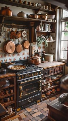 an old fashioned kitchen with many pots and pans