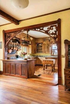 a large mirror in the middle of a room with wooden floors and cabinets on either side