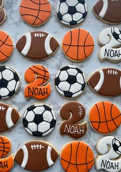 decorated cookies with sports balls and names are displayed on a marble countertop in front of the words noah, noah, noah