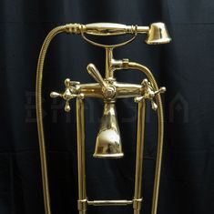 an old fashioned brass faucet with a bell on it's side and a black background