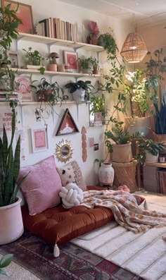 a living room filled with lots of plants and decor