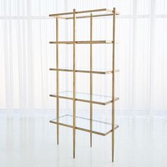 The Laforge Etagere features an iron frame with an antique gold finish and five clear, tempered glass shelves. For added design interest, the tapered legs are uniquely positioned at the middle of each side of the etagere as opposed to the corners, which is the typical placement. Available in a natural iron or antique gold finish. Gold Etagere, Bar Mirror, Tempered Glass Shelves, Coverlet Bedding, Etagere Bookcase, Storage Stool, Global Views, Bookcase Shelves, Drawer Liner